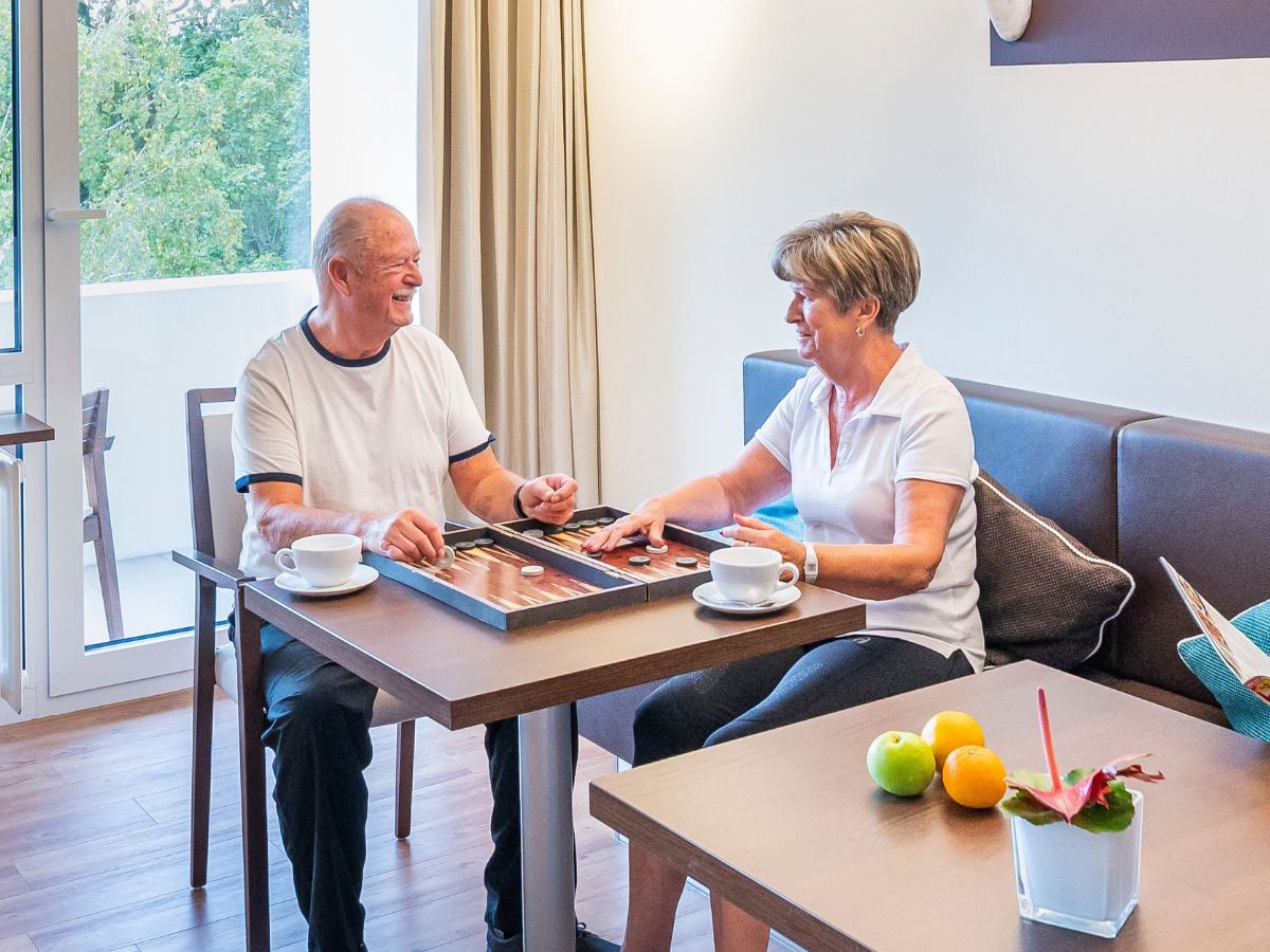 Zwei Personen die zusammen ein Brettspiel spielen 